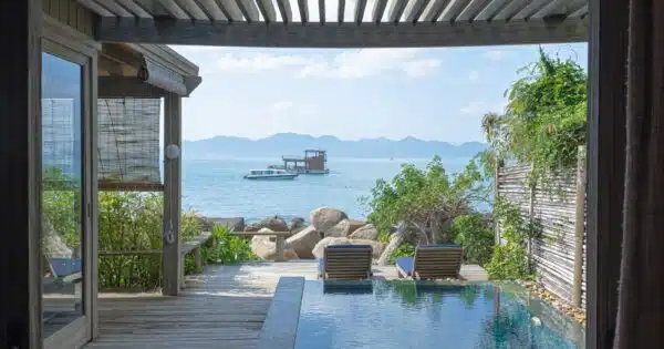 brown wooden chairs near swimming pool during daytime