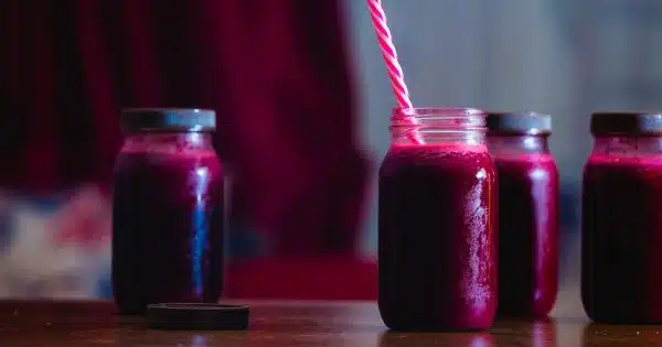 red beverage in mason jars